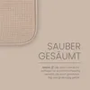 A close-up of a beige textured cushion with text describing its features. Anteprima dell’immagine prodotto