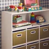 A white shelving unit filled with children's toys and storage baskets, set against a blue and white checkered wallpaper. Anteprima dell’immagine prodotto