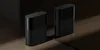 Two black mesh routers are placed on a wooden floor with dramatic lighting. Náhľad obrázku produktu