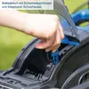 A hand is inserting a safety key into a battery compartment of a lawnmower. Produktbild-Vorschau