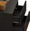Close-up view of the open drawers of a black nightstand. Podgląd zdjęcia produktu