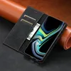 A black leather phone case with card slots and a phone displaying a colorful screen, placed on a brown leather surface. Produktbild-Vorschau