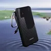 A black power bank is shown floating on water with a scenic background of hills and water. Produktbild-Vorschau