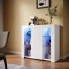 A white high-gloss sideboard with blue LED lighting is shown in a room with yellow walls and wooden floors. Produktbild-Vorschau