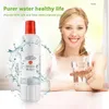 A woman is holding a glass of water next to a water filter. Water splashes around the filter. Produktbild-Vorschau
