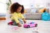 A young girl plays with a pink remote-controlled car in a living room. Náhľad obrázku produktu
