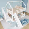 A children's bunk bed with a slide and stairs, set up in a bedroom with a blue and cloud-themed wall. Produktbild-Vorschau