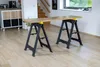 A workshop stand with a wooden plank on top, set up in a domestic environment. Produktbild-Vorschau