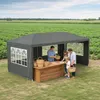 A family is at a market stall under a dark gray gazebo, with fields in the background. Voir les images du produit