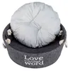 A round, gray pet bed with a light gray cushion inside, placed on a white background. Produktbild-Vorschau