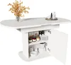 A white oval dining table with storage cabinets underneath, featuring jars, plates, and a small appliance. A vase with dried flowers is on the tabletop. Anteprima dell’immagine prodotto