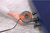 A hand is holding an electric air pump and connecting it to a blue inflatable mattress. Náhled obrázku produktu