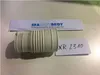 A white rubber bellows connector is placed on a white surface, with two pieces of paper behind it. One paper has a blue logo and text, and the other has handwritten text. Náhled obrázku produktu