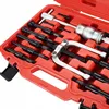 A red plastic case containing a set of tools, including a bearing puller and various attachments. Voir les images du produit