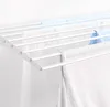 A close-up view of a white wall-mounted drying rack with laundry hanging on it. Produktbild-Vorschau