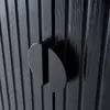 A close-up view of two black cabinet doors with ribbed texture and semicircular black handles. Produktbild-Vorschau
