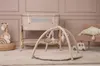 A nursery room setting with a baby play gym, a bassinet, and a chair. Produktbild-Vorschau