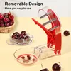 A cherry pitter tool is shown with cherries and pits. Náhled obrázku produktu