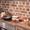 A kitchen counter with a glass stovetop protector featuring a fall harvest design, a frying pan, and ingredients for cooking. Náhled obrázku produktu