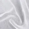A close-up view of white fabric with folds and texture. Náhled obrázku produktu