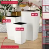 Three white planters of different sizes are displayed on a wooden floor, with a living room background. The planters have red labels indicating their sizes. Produktbild-Vorschau