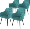 Four teal velvet dining chairs with quilted seats and black metal legs, arranged diagonally on a white background. Náhľad obrázku produktu