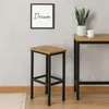 A bar stool and a table are set up in a room with a framed picture on the wall. Produktbild-Vorschau
