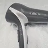 A close-up view of a black and silver hairdryer. Produktbild-Vorschau