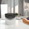 A dehumidifier sits on a marble countertop in a bathroom setting. Anteprima dell’immagine prodotto