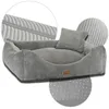 A grey corduroy dog bed with a small pillow, shown from a slightly elevated angle against a white background. Close-up insets highlight the fabric texture and the non-slip bottom. Produktbild-Vorschau