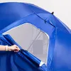 A close-up view of a blue umbrella-like structure, possibly a beach tent or sunshade, with a mesh window being held open by a hand. Anteprima dell’immagine prodotto