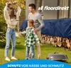 A family is gathered in a yard with a pile of firewood covered by a blue tarp. A grill is in the foreground. Anteprima dell’immagine prodotto