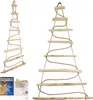 Two wooden Christmas tree decorations hanging against a white background. One is a close-up of the top half, and the other is a full view. A small box with lights and a clear container are in the bottom left corner. Náhled obrázku produktu