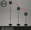 Three black floor lamps are shown at different heights, illustrating the adjustable feature. Red arrows indicate rotational and height adjustment points. A circular graphic with '3 in 1' is in the top left corner. The bottom of the image has a black bar wi Produktbild-Vorschau