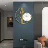 A modern living room with a decorative wall clock featuring a wheat motif. Produktbild-Vorschau