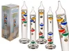 A group of Galileo thermometers are displayed next to their packaging. Produktbild-Vorschau