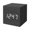 A black digital alarm clock with a wood grain texture is shown against a white background. Produktbild-Vorschau