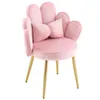 A pink velvet chair with gold legs and a bow-shaped pillow. Podgląd zdjęcia produktu