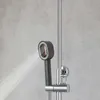 A shower head spraying water against a concrete wall. Podgląd zdjęcia produktu