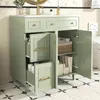 A green bathroom vanity with its doors and drawers open, showcasing storage space and toiletries. Anteprima dell’immagine prodotto