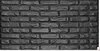 A close-up, full-frame shot of a dark gray brick wall. Produktbild-Vorschau