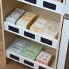 Close-up of toy food boxes on shelves of a toy market stand. Produktbild-Vorschau