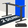 A black standing desk frame with a control panel shown in the foreground, set against a white and blue background. Podgląd zdjęcia produktu