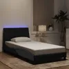 A bedroom scene with a bed and a plant. Podgląd zdjęcia produktu