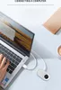 A person's hand is typing on a laptop keyboard, with a small white camera connected to the laptop via a white cable. Anteprima dell’immagine prodotto