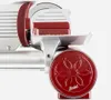 A close-up side view of a red and silver meat slicer. Voir les images du produit