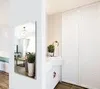 A hallway or entryway with a mirror and a closet. Produktbild-Vorschau
