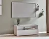 A white TV lowboard is shown mounted on a light green wall, with a television above it and decorative plants on the wall. Produktbild-Vorschau