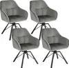 Four dark gray velvet dining chairs with black metal legs are arranged in a grid formation against a white background.