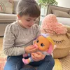 A young girl is playing with a doll in a living room setting. Voir les images du produit